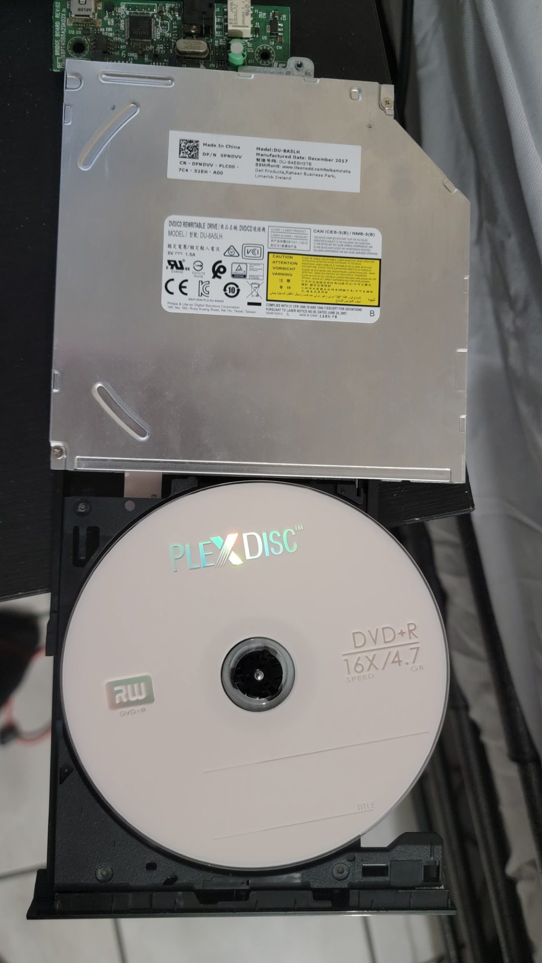 The LiteOn (PLDS) DU-8A5LH Optical Drive with a PlexDisc DVD+R disc.